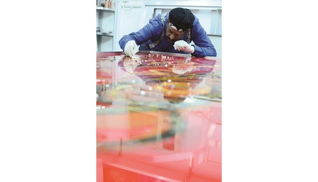 COLOURS AND GEMS: Painter Patric Rozario working on his latest creation at his studio in Doha.  Photo by Anand Holla