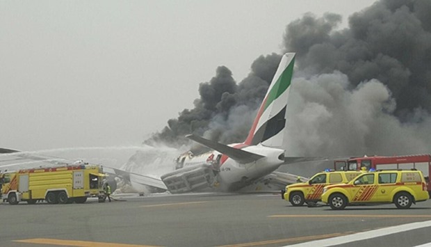 Thick black smoke billows from the aircraft after the crash in Dubai on Wednesday.