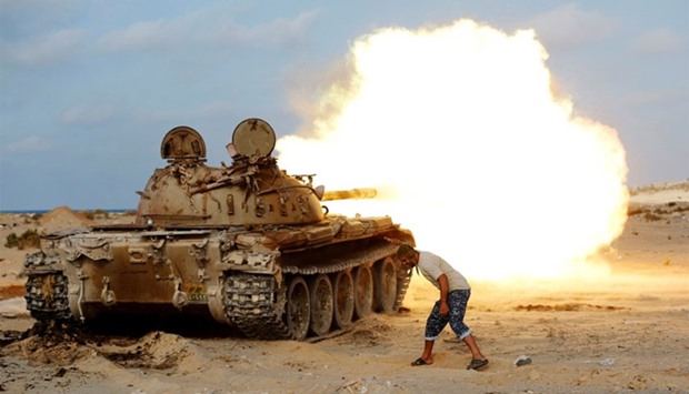 A fighter of Libyan forces allied with the UN-backed government fires a shell with Soviet made T-55 tank at Islamic State fighters in Sirte.