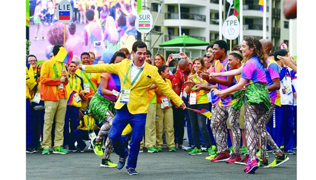 A member of Colombiau2019s Olympic team performs with dancers during a welcoming ceremony at the Athletesu2019 Village ahead of the Rio 2016 Olympic Games.