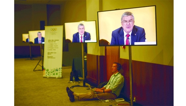 International Olympic Committee (IOC) President Thomas Bach is broadcast on television screens as he speaks during the 129th International Olympic Committee session, in Rio de Janeiro.