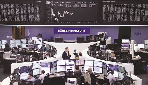 Traders work at the Frankfurt Stock Exchange. The DAX 30 gained 0.3% to 10,170.21 points yesterday.