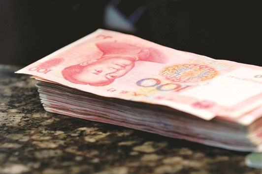 Chinese 100 yuan banknotes are seen on a counter of a branch of a commercial bank in Beijing.