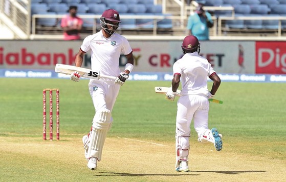 West Indies batsmen Roston Chase (L)and Jermaine Blackwood score a run off a delivery from bowler Mohammed Shami of India on day five of their second Test match at Sabina Park in Kingston, Jamaica.