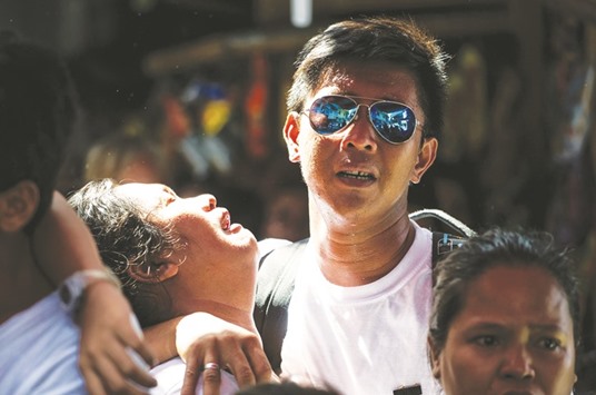 Relatives of Michael Siaron grieve during his burial ceremony at a cemetery in Manila yesterday. Siaron was killed by suspected vigilantes on July 22 acting on President Rodrigo Duterteu2019s call to kill all the countryu2019s drug dealers.