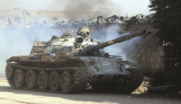 A Free Syrian Army fighter looks out of a tank in Ramussa area southwest of Aleppo, Syria on Tuesday.