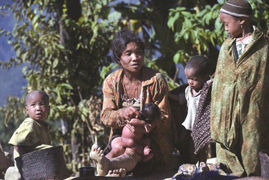 This photograph taken on December 24, 2014 shows a Naga ethnic woman bathing her child in Lahal township in the remote Sagaing region located in northern Myanmar. An undiagnosed disease has killed more than 30 children in a remote part of Myanmar, officials said yesterday.