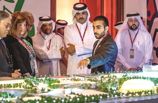 HE Sheikh Joaan and guests look at Qataru2019s Supreme Committee scaled model.