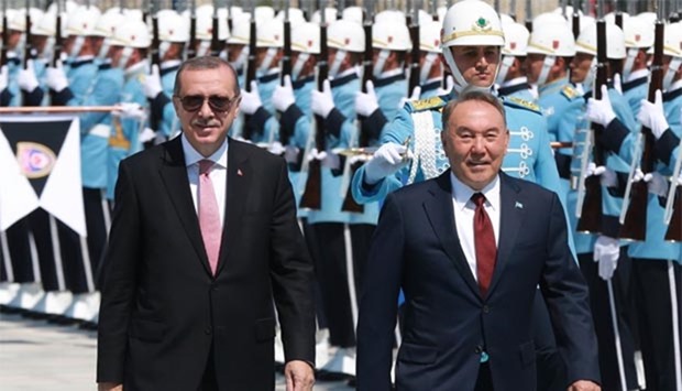 Turkish President Recep Tayyip Erdogan and Kazakhstan's President Nursultan Nazarbayev review the honour guard at the Presidential Complex in Ankara on Friday.