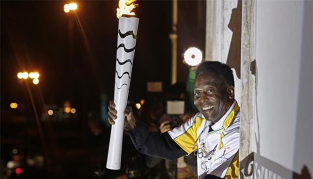 Pele holds the Olympic flame at the Pele Museum in Santos, Sao Paulo state in this file photo.