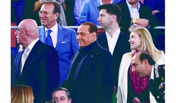 This file photo taken on May 21, 2016 shows AC Milan president Silvio Berlusconi (C), vice-president Adriano Galliani (L) and board member Barbara Berlusconi (R) arrive for the Italian Tim Cup final football match AC Milan vs Juventus at the Olympic Stadium in Rome.  Silvio Berlusconi agreed yesterday to sell more than 99 percent of AC Milan to a group of Chinese investors, announced Fininvest, the holding company of the Berlusconi family.