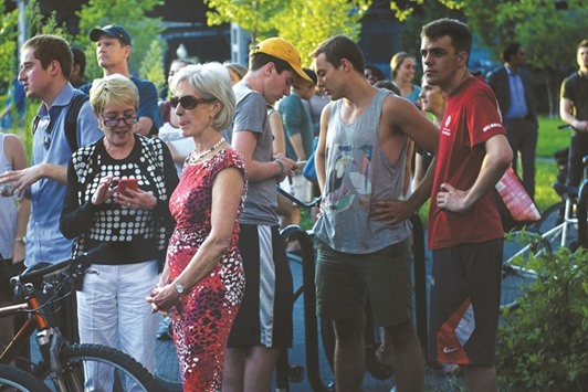 Former secretary of health and human services Kathleen Sebelius waits with others as they are held back by Secret Service as US President Barack Obama has a birthday meal at Fiola Mare in Washington.