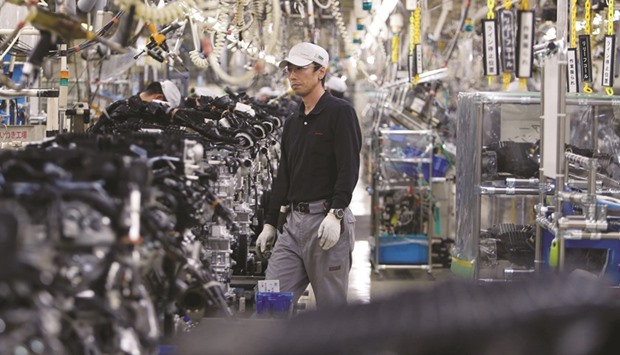 Employees work at the main assembly line of V6 engine at the Nissan Iwaki Plant in Iwaki city. Japanu2019s gross domestic product was expected to expand at an annualised rate of 0.7% in April-June, the poll of 21 analysts showed yesterday.