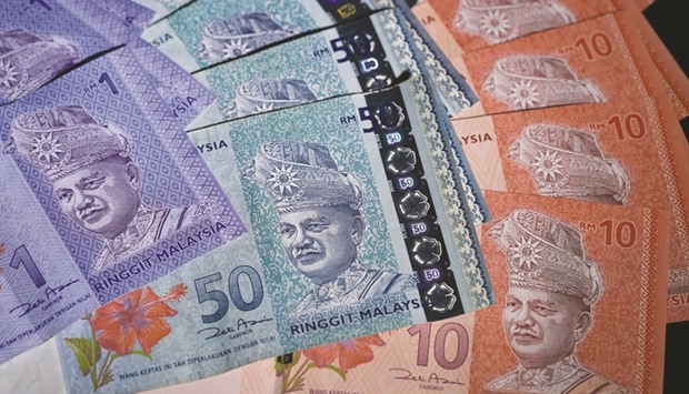 Malaysian ringgit banknotes of various denominations are seen in an arranged photograph in Tokyo. The ringgit is the regionu2019s biggest loser in the past month and analysts still see scope for it to drop more than 2% by year-end.