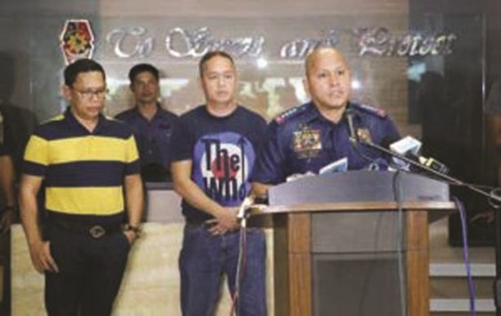 Director General Ronald u2018Batou2019 de la Rosa (right) presents to the media two of three Mindanao politicians linked to illegal drugs. Maguing, Lanao del Sur Mayor Mamaulan Abinal Molok (left) and Ali Abinal (centre), former mayor of Marantao town also in Lanao de Sur, surrendered hours after the President gave a u2018shoot on sightu2019 order to authorities hunting down 27 u2018narco-politicians.u2019