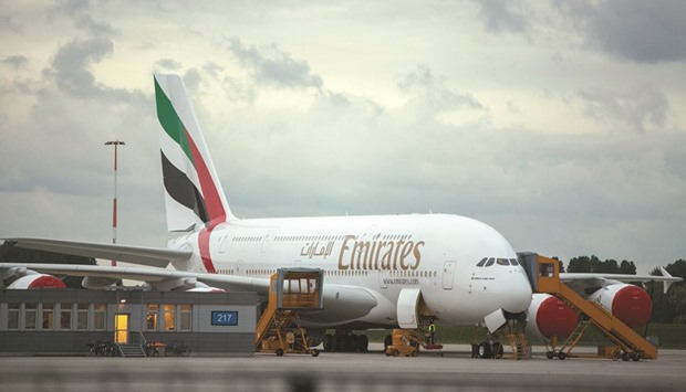 An Airbus A380-800 aircraft displaying Emirates airline livery stands at the Airbus Group plant in Hamburg, Germany (file). Emirates will take delivery of 21 A380s in the fiscal year through March 2017.