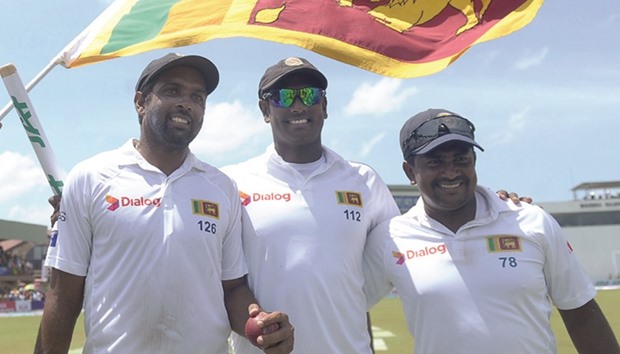 Sri Lanka captain Angelo Mathews, (C) and teammates Rangana Herath (L) and Dilruwan Perera leave the ground after their victory over Australia at The Galle International Cricket Stadium in Galle yesterday.