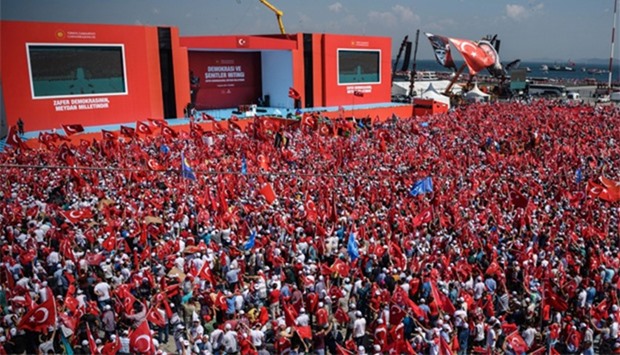 Demonstrators wave Turkish national flags in Istanbul during a rally against failed military coup