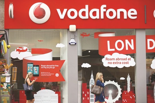 People walk in front of a Vodafone store in central London. Europeu2019s largest mobile phone operator has issued $1.3bn of notes due in August 2056, according to data compiled by Bloomberg.