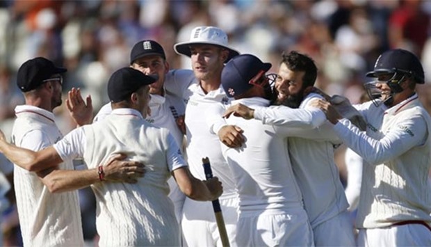 England's Moeen Ali celebrates with his teammates after taking the wicket of Pakistan's Sohail Khan, winning the third Test at Edgbaston on Sunday.