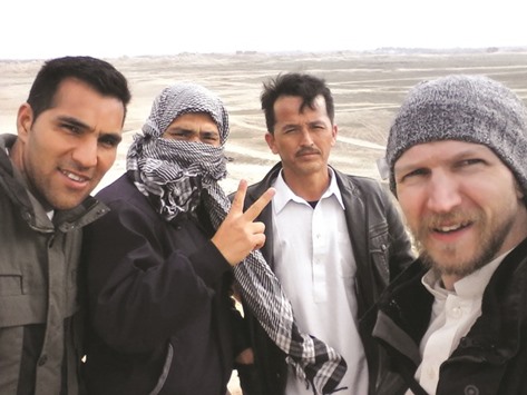 This photograph received from Irish tourist Jonny Blair on August 6, shows Blair (right) with three Afghan men during his travels in Afghanistan.