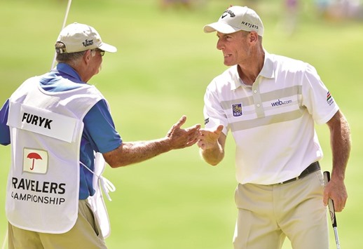 Jim Furyk (right) of the United States celebrates with his caddie Mike Cowan after shooting a record-setting 58 in the final round of the Travelers Championship in Cromwell, Connecticut, yesterday. (AFP)