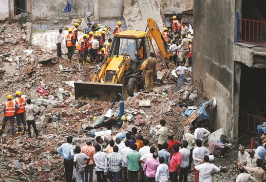 Rescuers search for survivors at the site of a collapsed residential building in Bhiwandi.