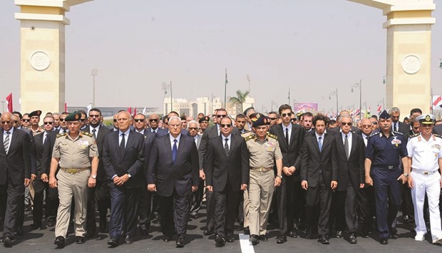Egyptian President Abdel Fattah al-Sisi walks during a military funeral ceremony with Egyptian government officials and relatives of Egyptian-American Ahmed Zewail worldu2019s Nobel Prize in chemistry, who died last Tuesday for 70 years in the United States at El-Mosheer Tantawy Mosque in Cairo yesterday.