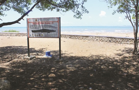 This picture taken on July 27 shows a sign alerting people to the crocodile threat on a beach in Kupang, in East Nusa Tenggara province.