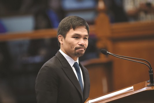 Philippine boxing icon-turned-senator Manny Pacquiao ponders as he is interpelated by a colleague after delivering his privilege speech on restoration of the death penalty during a session at the senate in Manila on August 8, 2016.