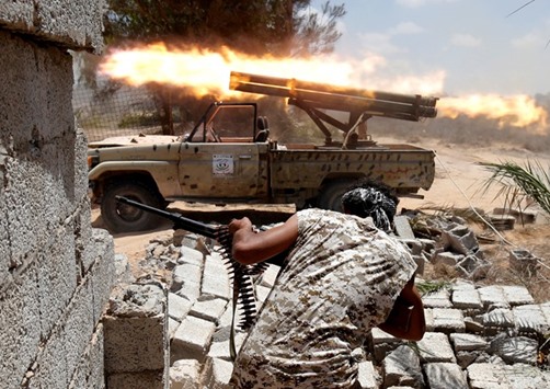 Libyan forces allied with the UN-backed government fire weapons during a battle with IS fighters in Sirte.