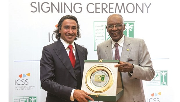 ICSS president Mohammed Hanzab presenting SAFF president Ahmed Eid al-Harbi with a shield.
