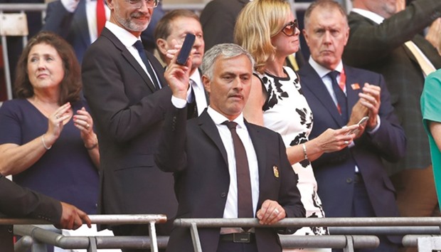 Manchester United manager Jose Mourinho celebrates after winning the FA Community Shield as Sir Geoff Hurst applauds.