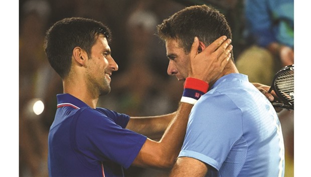 Novak Djokovic (left) congratulates Juan Martin del Potro. (AFP)