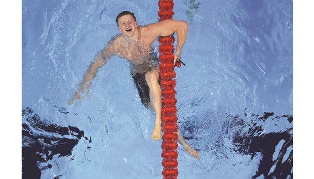 Britainu2019s Adam Peaty celebrates after he broke the world record to win the menu2019s 100m breaststroke final at the Olympic Aquatics Stadium in Rio de Janeiro on Sunday. (AFP)