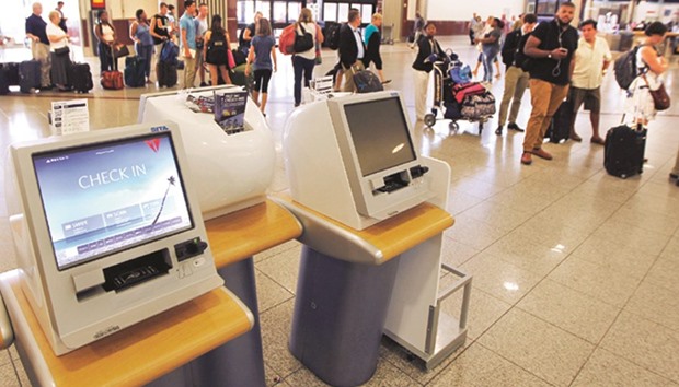 Non-working Delta kiosks are empty as passengers line up to check in after Delta Air Linesu2019 computer systems crashed yesterday, grounding flights around the globe, at Hartsfield Jackson Atlanta International Airport yesterday.