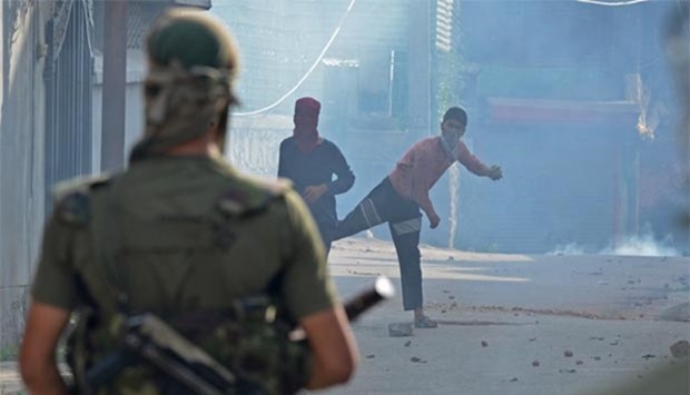 Kashmiri protesters throw stones at Indian government forces in the Batmaloo area of Srinagar on Tuesday.