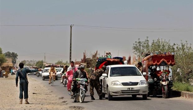 Afghan policemen search commuters at a checkpoint in Helmand province on Tuesday.