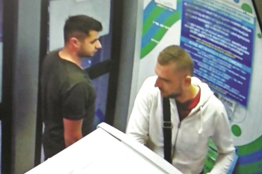 Alleged Romanian skimmers Bogdean Florian (facing ATM) and Gabriel Marian captured on the banku2019s CCTV.