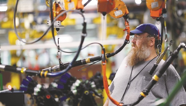 An employee works on diesel truck engines at the Cummins Mid-Range Engine Plant in Columbus, Indiana. The measure of employee output per hour in the US decreased at a 0.5% annualised rate in the three months through June after dropping 0.6% in the prior quarter, a Labor Department report showed in Washington yesterday.