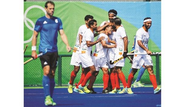 Chinglensana Singh (centre) of India celebrates with his teammates after scoring a goal against Argentina during the hockey menu2019s Pool B match yesterday. (Reuters /  Sergio Moraes)