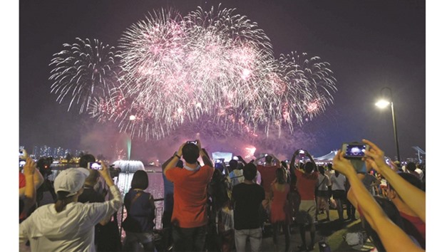 Fireworks burst over the Singapore National Stadium during National Day celebrations.