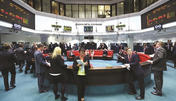Traders stand outside the open outcry pit following a trading session at the London Metal Exchange. The LME is moving into gold to capture part of the $5tn over-the-counter market in London, the global hub for trading the metal, as regulators push for more curbs over commodities trading and centralised clearing.