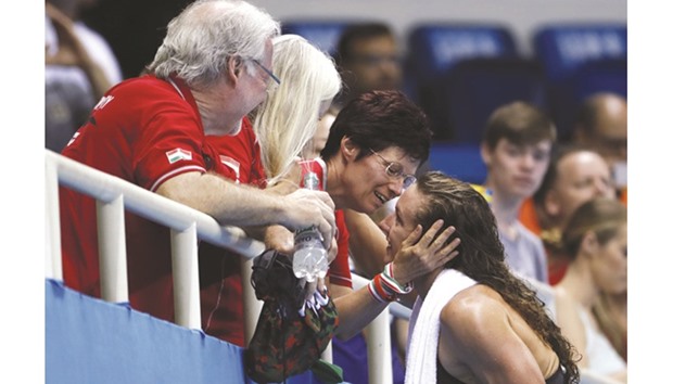 Hungaryu2019s Katinka Hosszu (right) is congratulated by relatives after she won the womenu2019s 100m backstroke gold on Monday. (AFP)