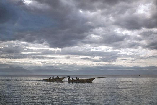 This file photo taken on March 22, 2015 shows fishing boats returning to dock on the shores of Lake Tanganyika in Uvira. Fish are becoming more scarce in Africau2019s oldest and deepest lake, Lake Tanganyika, because of climate warming, not just overfishing, US researchers said this week.