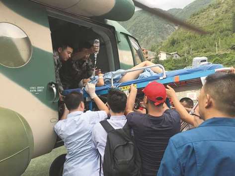 Rescuers transfer a survivor, injured during an earthquake, by a helicopter to Sichuan Provincial Peopleu2019s Hospital in Jiuzhaigou in Chinau2019s southwestern Sichuan province.