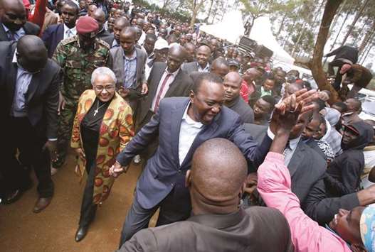 This picture taken on Tuesday shows Kenyatta greeted by supporters after casting his vote in his hometown of Gatundu in Kiambu county.