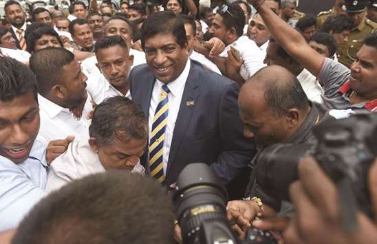 Former Sri Lankan foreign minister Ravi Karunanayake leaves after resigning in Colombo.