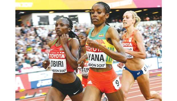 Hellen Onsando Obiri (left) of Kenya, Almaz Ayana (centre) of Ethiopia and Susan Krumins of the Netherlands compete in the womenu2019s 5,000m heats at the IAAF World Athletics Championships in London yesterday. (Reuters)