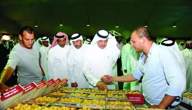 HE the Minister of Municipality and Environment Mohamed bin Abdullah al-Rumaihi inspects some of the dates on sale at the ongoing Local Dates Festival at Souq Waqif. PICTURE: Shemeer Rasheed